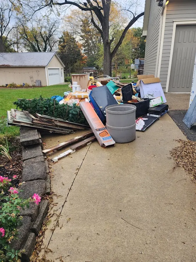 Dumpster being loaded with debris for Roofing Dumpster Rental in Kurtistown